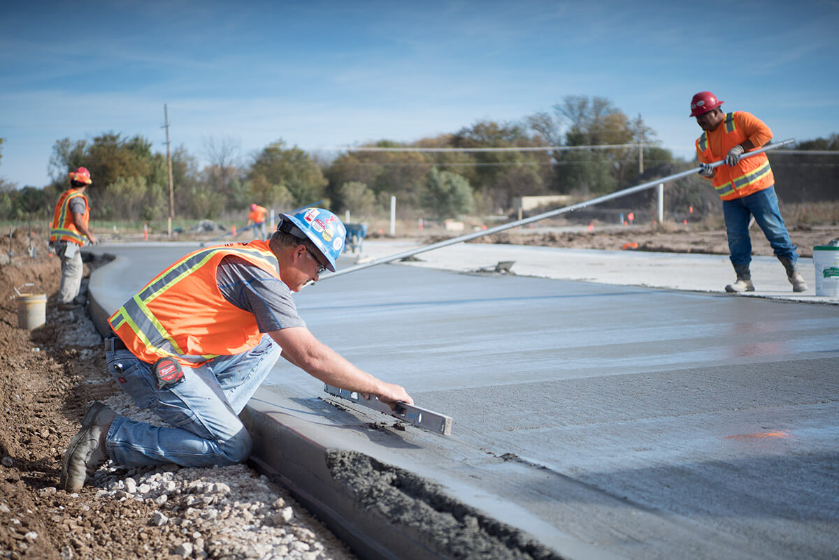 Concrete contractors leveling a fresh pour in Lakeland, Florida